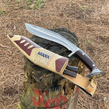 Decorative khukuri with sheath on a wooden stump against a natural background